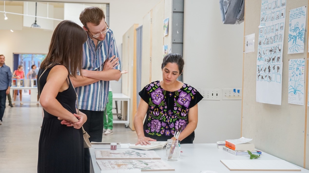 During SFAI’s monthly Open Studios events, members of the public have an opportunity to engage with our resident artists. Here, resident artist Bertha Aguilar Garcia explains her work to two SFAI supporters.
