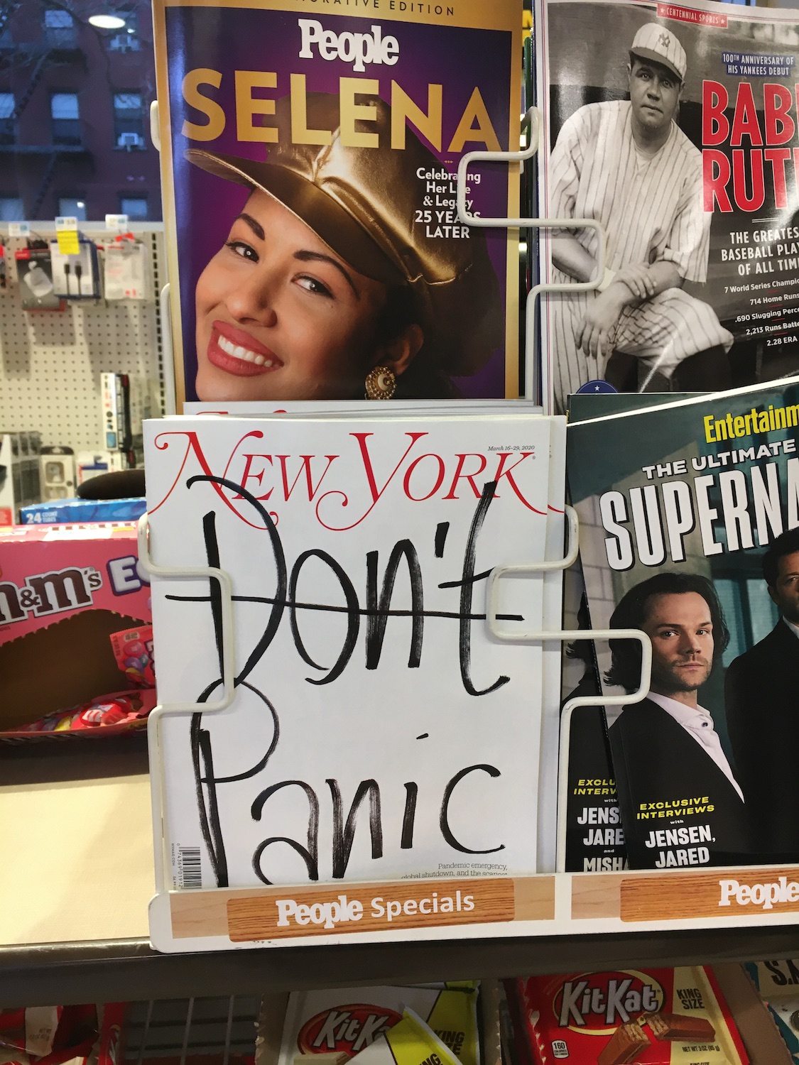 The “New York” magazine on the supermarket shelf writes “Don’t Panic” on its cover. 